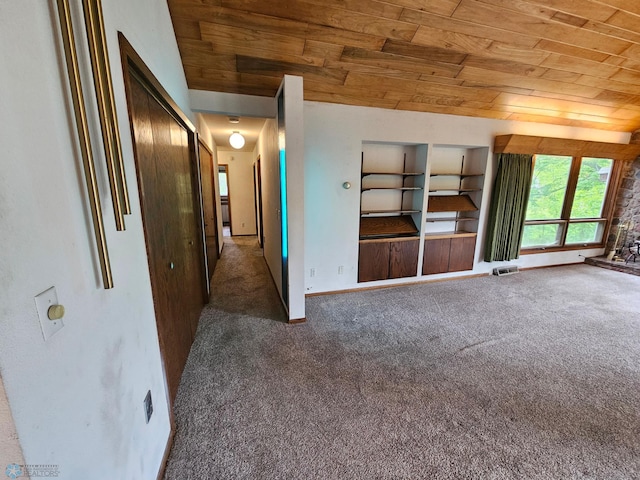 103 4th St S, Fairmount, ND 58030 - unfurnished living room with wooden ceiling, carpet floors, and baseboards