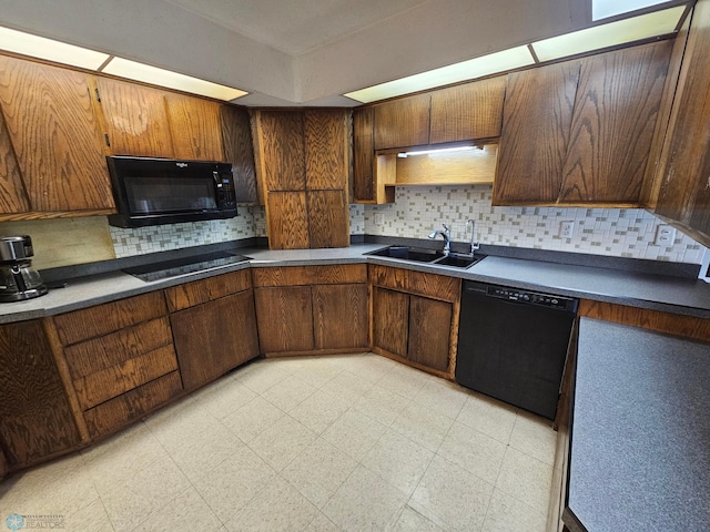 103 4th St S, Fairmount, ND 58030 - kitchen featuring black appliances, a sink, decorative backsplash, light flooring, and dark countertops