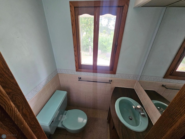 103 4th St S, Fairmount, ND 58030 - bathroom featuring a wainscoted wall, toilet, vanity, tile walls, and tile patterned floors