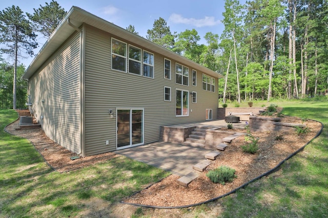 23904 Summer Haven Ln, Nisswa, MN 56468 - rear view of house with a patio area, a lawn, and central AC unit