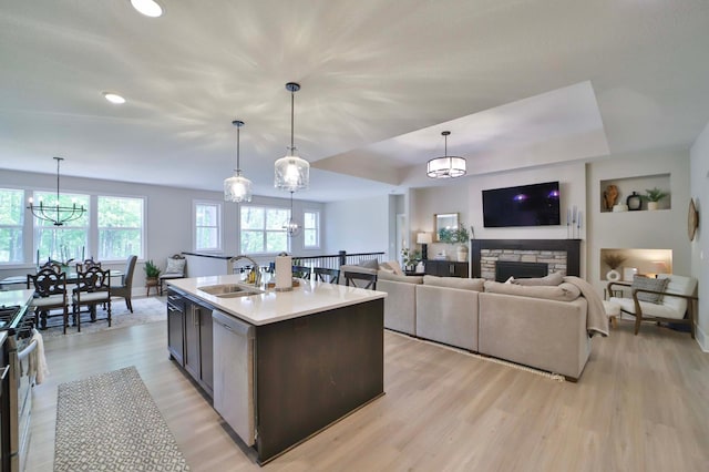 23904 Summer Haven Ln, Nisswa, MN 56468 - kitchen featuring a sink, a chandelier, light wood-style floors, baseboards, and healthy amount of natural light