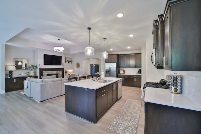 23904 Summer Haven Ln, Nisswa, MN 56468 - kitchen featuring stainless steel appliances, dark brown cabinets, a sink, light countertops, and recessed lighting