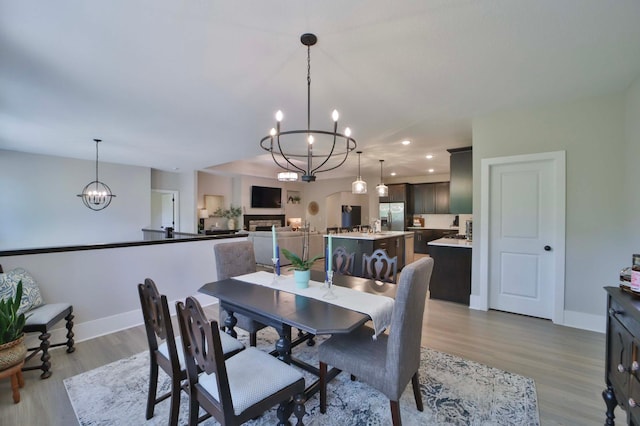 23904 Summer Haven Ln, Nisswa, MN 56468 - dining room with a chandelier, wood finished floors, baseboards, and recessed lighting