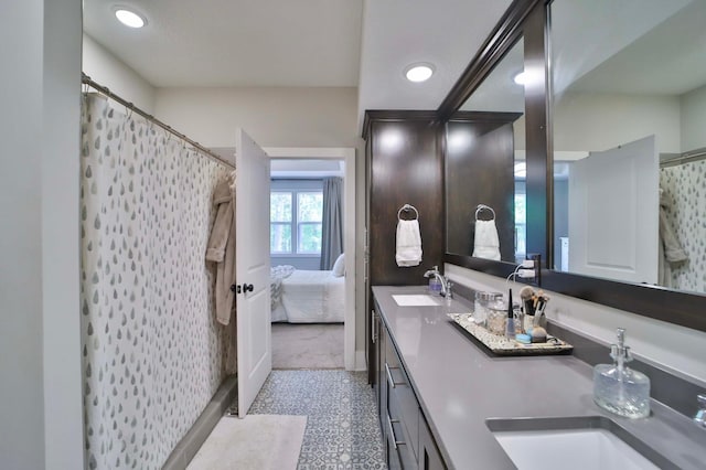 23904 Summer Haven Ln, Nisswa, MN 56468 - ensuite bathroom with double vanity, curtained shower, baseboards, and recessed lighting