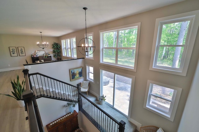 23904 Summer Haven Ln, Nisswa, MN 56468 - staircase with a chandelier, baseboards, and wood finished floors