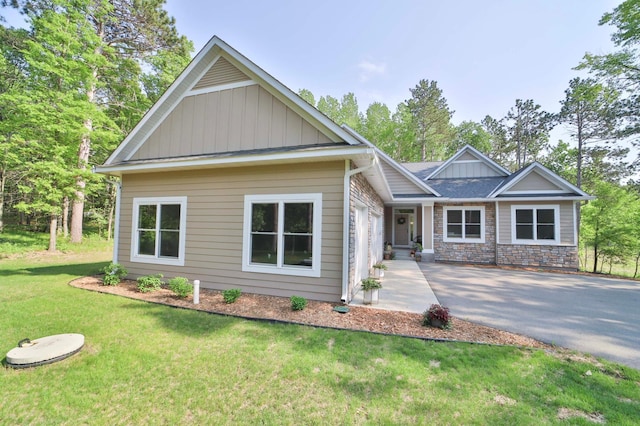 23904 Summer Haven Ln, Nisswa, MN 56468 - craftsman house with asphalt driveway, board and batten siding, a front lawn, and stone siding