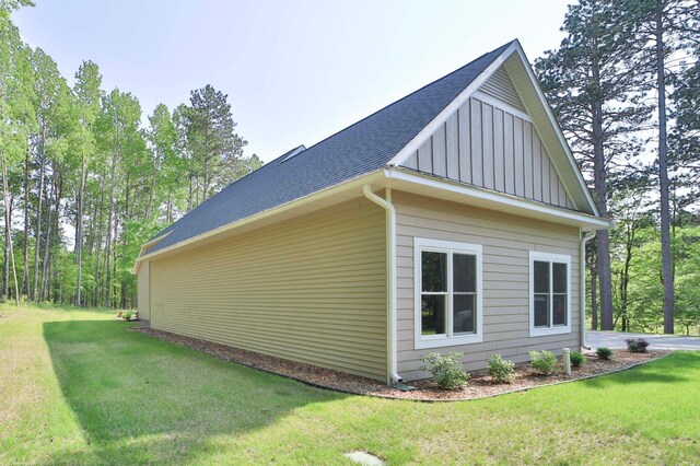 23904 Summer Haven Ln, Nisswa, MN 56468 - view of side of property featuring board and batten siding, roof with shingles, and a lawn