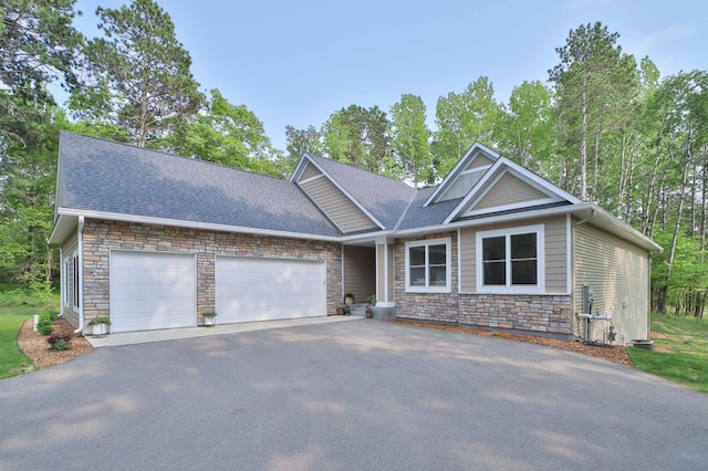 23904 Summer Haven Ln, Nisswa, MN 56468 - craftsman-style home with driveway, stone siding, a garage, and roof with shingles