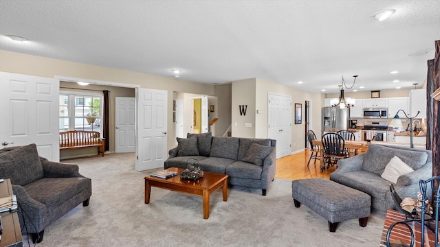 8548 139th St, Savage, MN 55378 - living room with light carpet, recessed lighting, a textured ceiling, stairway, and baseboards