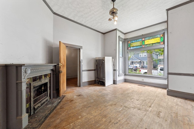 691 Burr St, Saint Paul, MN 55130 - unfurnished living room with crown molding, hardwood / wood-style floors, a fireplace, baseboards, and a textured ceiling