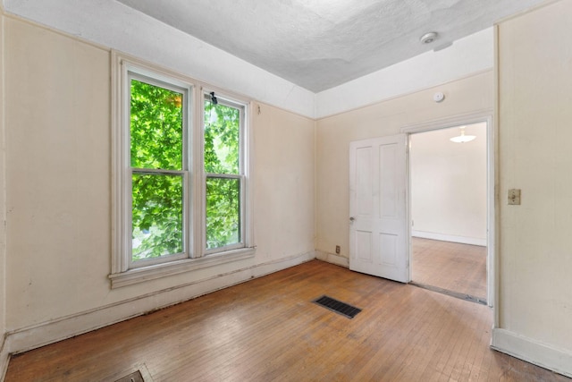 691 Burr St, Saint Paul, MN 55130 - unfurnished bedroom featuring hardwood / wood-style flooring and a textured ceiling