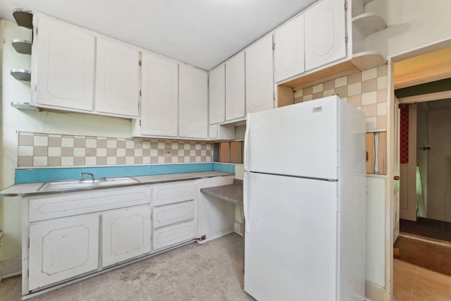 691 Burr St, Saint Paul, MN 55130 - kitchen with freestanding refrigerator, a sink, open shelves, white cabinets, and backsplash