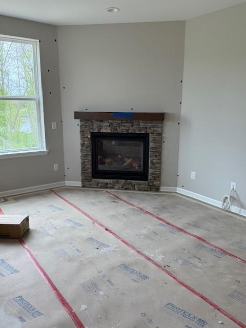 10051 Mulberry Ln, Corcoran, MN 55374 - unfurnished living room featuring a fireplace and baseboards