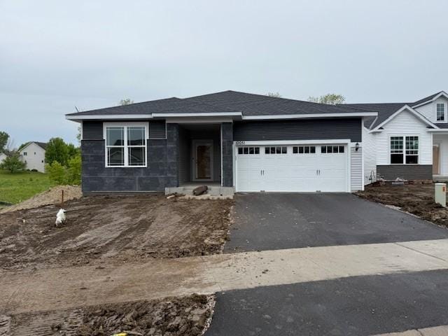 10051 Mulberry Ln, Corcoran, MN 55374 - view of front of house with an attached garage and asphalt driveway