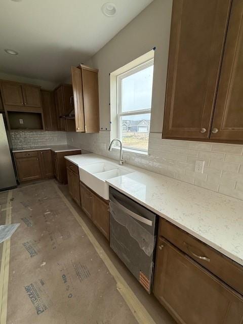 10051 Mulberry Ln, Corcoran, MN 55374 - kitchen featuring appliances with stainless steel finishes, a sink, backsplash, and light stone counters