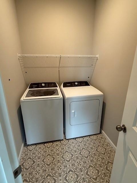 10051 Mulberry Ln, Corcoran, MN 55374 - laundry room with washing machine and clothes dryer, baseboards, and light flooring