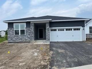 10051 Mulberry Ln, Corcoran, MN 55374 - view of front of house with driveway, a garage, and stone siding