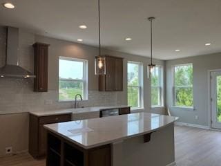 10051 Mulberry Ln, Corcoran, MN 55374 - kitchen featuring wall chimney range hood, light wood finished floors, a kitchen island, recessed lighting, and light countertops