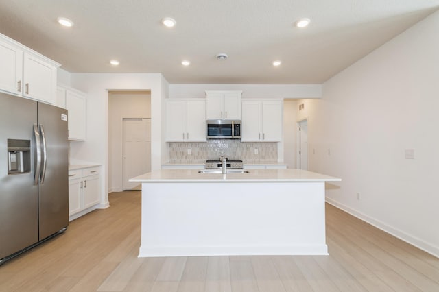 22615 Isla Way, Rogers, MN 55374 - kitchen with appliances with stainless steel finishes, a sink, light countertops, light wood-style flooring, and recessed lighting