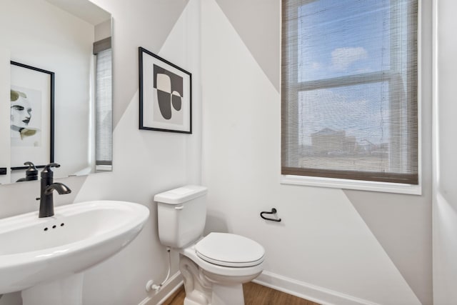 15072 Sycamore St NW, Andover, MN 55304 - bathroom featuring a sink, toilet, baseboards, and wood finished floors