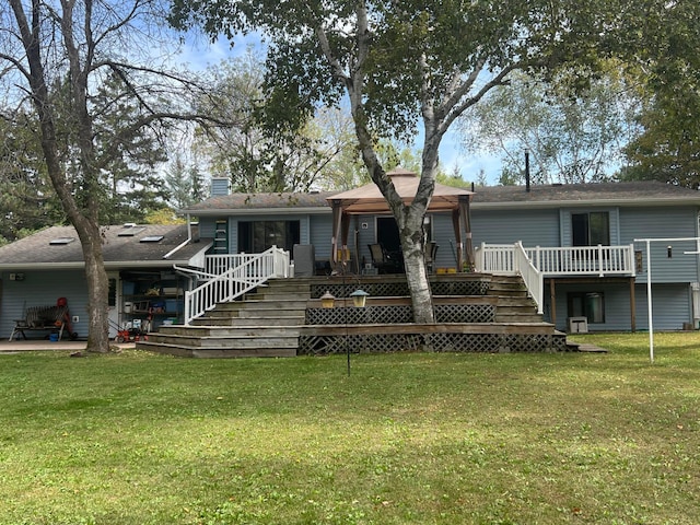 25070 Goodview Ave, Wyoming, MN 55092 - view of front facade featuring stairway, a chimney, a front lawn, a wooden deck, and a patio