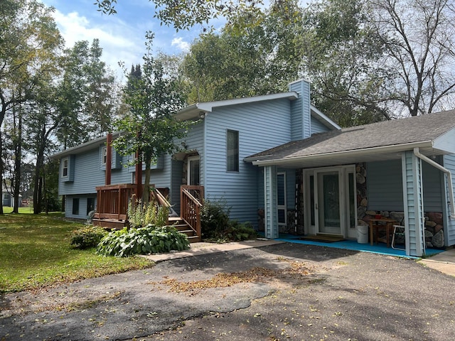 25070 Goodview Ave, Wyoming, MN 55092 - back of house with a chimney, a wooden deck, a lawn, and a shingled roof