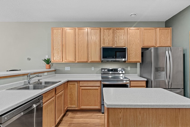 4707 Blaine Ave Unit 709, Inver Grove Heights, MN 55076 - kitchen with appliances with stainless steel finishes, a sink, light countertops, light wood-type flooring, and light brown cabinets