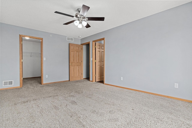 4707 Blaine Ave Unit 709, Inver Grove Heights, MN 55076 - unfurnished bedroom featuring a walk in closet, baseboards, carpet flooring, and a closet