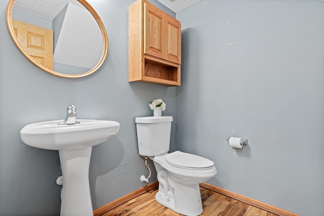 4707 Blaine Ave Unit 709, Inver Grove Heights, MN 55076 - bathroom featuring wood finished floors, baseboards, and toilet