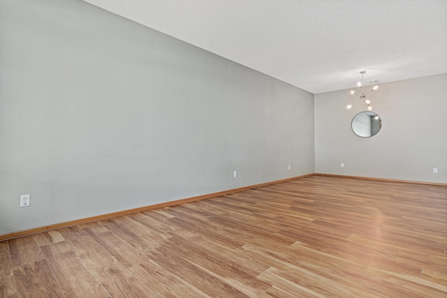 4707 Blaine Ave Unit 709, Inver Grove Heights, MN 55076 - empty room featuring light wood-type flooring, baseboards, and a chandelier