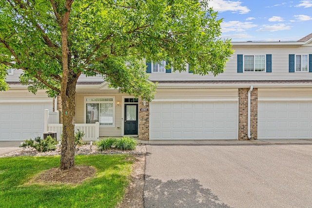 4707 Blaine Ave Unit 709, Inver Grove Heights, MN 55076 - multi unit property with brick siding, covered porch, asphalt driveway, and an attached garage