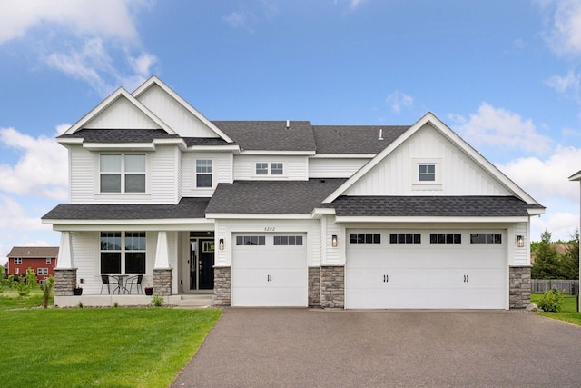 5282 Randolph Ave NE, Otsego, MN 55374 - view of front of property featuring asphalt driveway, a porch, board and batten siding, a front yard, and roof with shingles