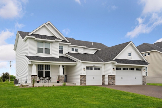 5282 Randolph Ave NE, Otsego, MN 55374 - view of front of house with a porch, stone siding, asphalt driveway, an attached garage, and a front yard