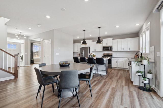 5282 Randolph Ave NE, Otsego, MN 55374 - dining space featuring recessed lighting, light wood-style flooring, a chandelier, stairway, and baseboards