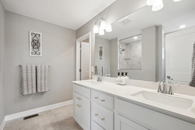 5282 Randolph Ave NE, Otsego, MN 55374 - full bathroom featuring double vanity, baseboards, tiled shower, and tile patterned floors