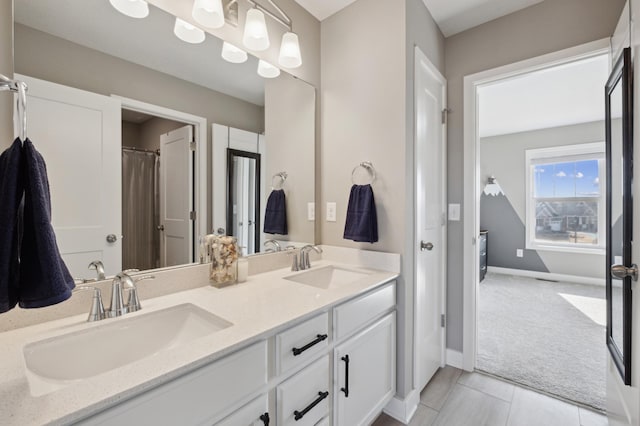 5282 Randolph Ave NE, Otsego, MN 55374 - bathroom featuring double vanity and baseboards