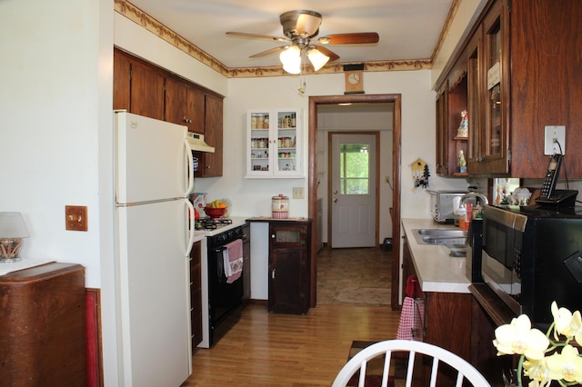 44500 Elmcrest Ave, Fish Lake Twp, MN 55032 - kitchen featuring gas stove, freestanding refrigerator, ceiling fan, light countertops, and a sink