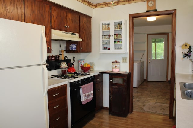 44500 Elmcrest Ave, Fish Lake Twp, MN 55032 - kitchen with freestanding refrigerator, black gas range, under cabinet range hood, light countertops, and washer / dryer