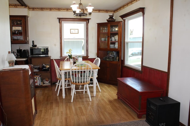 44500 Elmcrest Ave, Fish Lake Twp, MN 55032 - dining area featuring healthy amount of natural light, light wood-type flooring, a chandelier, and wainscoting