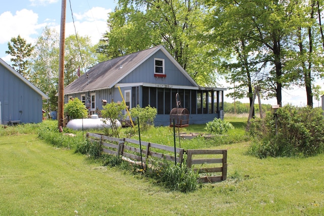 44500 Elmcrest Ave, Fish Lake Twp, MN 55032 - rear view of house featuring a sunroom and a lawn