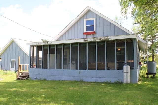 44500 Elmcrest Ave, Fish Lake Twp, MN 55032 - view of property exterior featuring board and batten siding, a sunroom, and a lawn