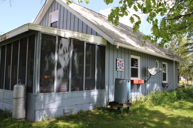 44500 Elmcrest Ave, Fish Lake Twp, MN 55032 - view of side of home with a sunroom, roof with shingles, and board and batten siding