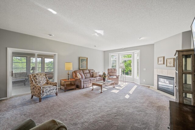 17260 Keystone Ave N, Hugo, MN 55038 - carpeted living room featuring a tiled fireplace, a textured ceiling, and baseboards