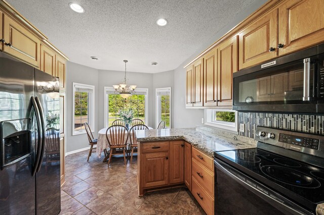 17260 Keystone Ave N, Hugo, MN 55038 - kitchen with stainless steel range with electric stovetop, refrigerator with ice dispenser, a chandelier, a textured ceiling, and light stone countertops