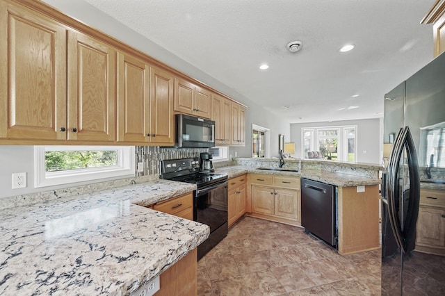 17260 Keystone Ave N, Hugo, MN 55038 - kitchen featuring black appliances, a peninsula, a sink, light stone countertops, and recessed lighting