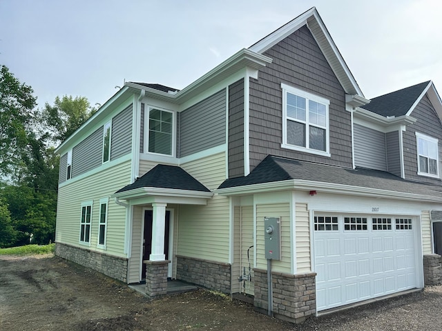 20017 62nd Pl, Corcoran, MN 55340 - view of front of home featuring an attached garage, stone siding, and roof with shingles