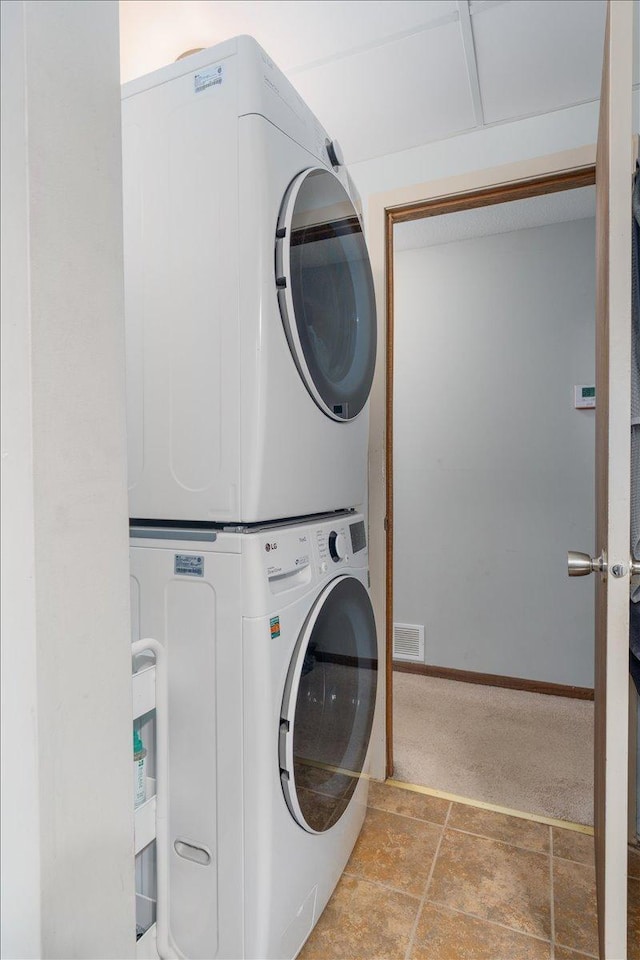 106 1/2 N St, Hudson, WI 54016 - laundry room with stacked washing machine and dryer and stone finish flooring