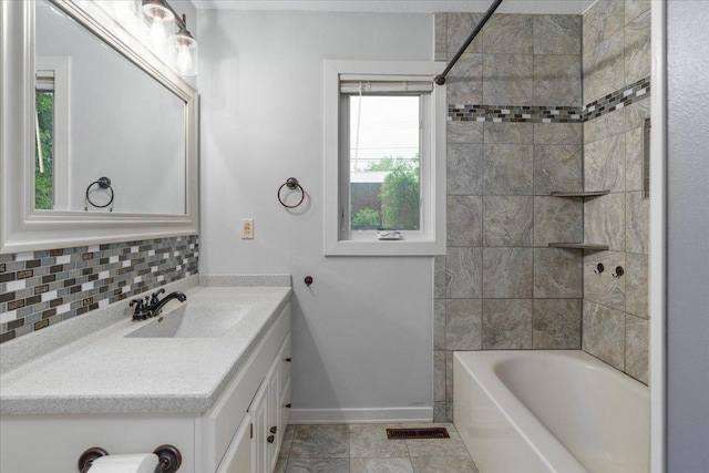 106 1/2 N St, Hudson, WI 54016 - full bath with vanity, backsplash, tub / shower combination, and baseboards