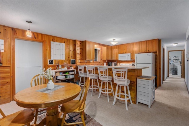 106 1/2 N St, Hudson, WI 54016 - dining room featuring light colored carpet and wood walls