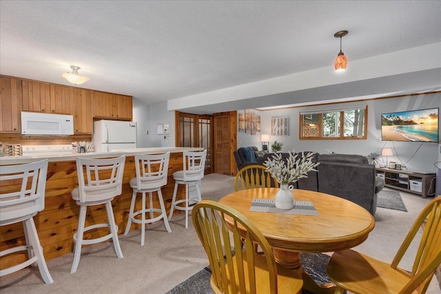 106 1/2 N St, Hudson, WI 54016 - dining space featuring light colored carpet and a textured ceiling